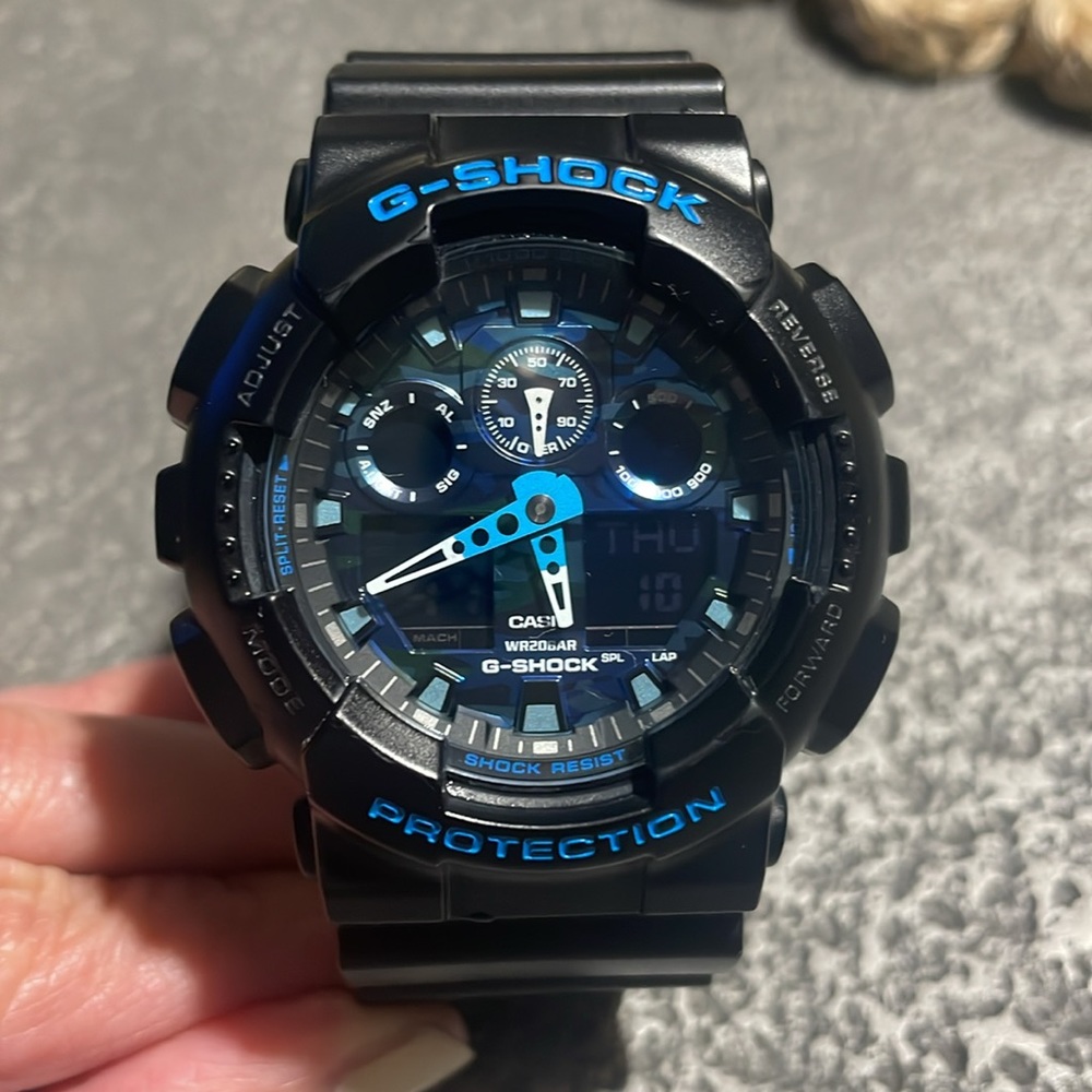 G-Shock GA-100 series. Black with blue accents.